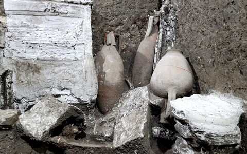 The two small rooms included wooden cupboards, shelves on which cups, plates and other crockery rested