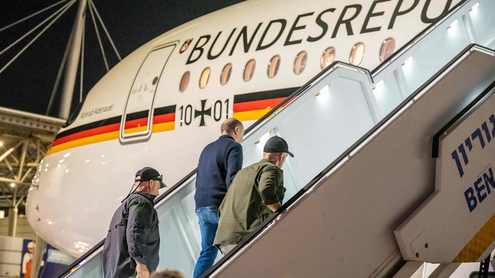 Der Kanzler wird nach dem Alarm von Sicherheitsbeamten ins Flugzeug gebracht